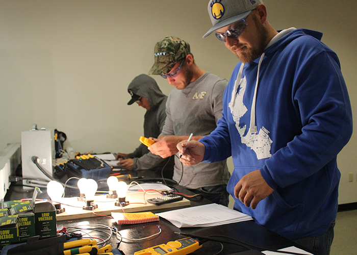 Students wiring circuits at a hands-on WECA electrical lab
