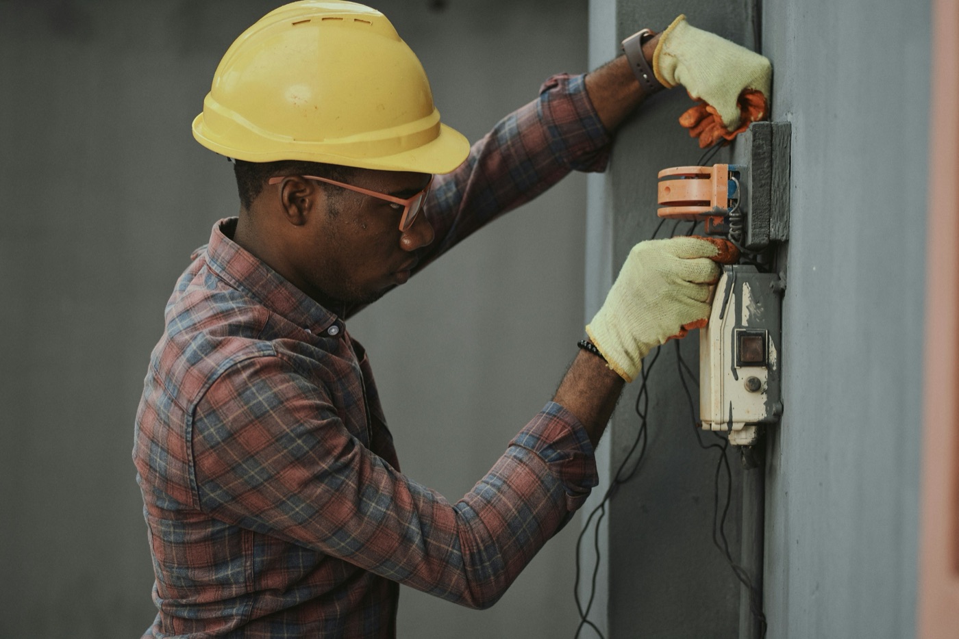 An electrician installing equipment on a jobsite