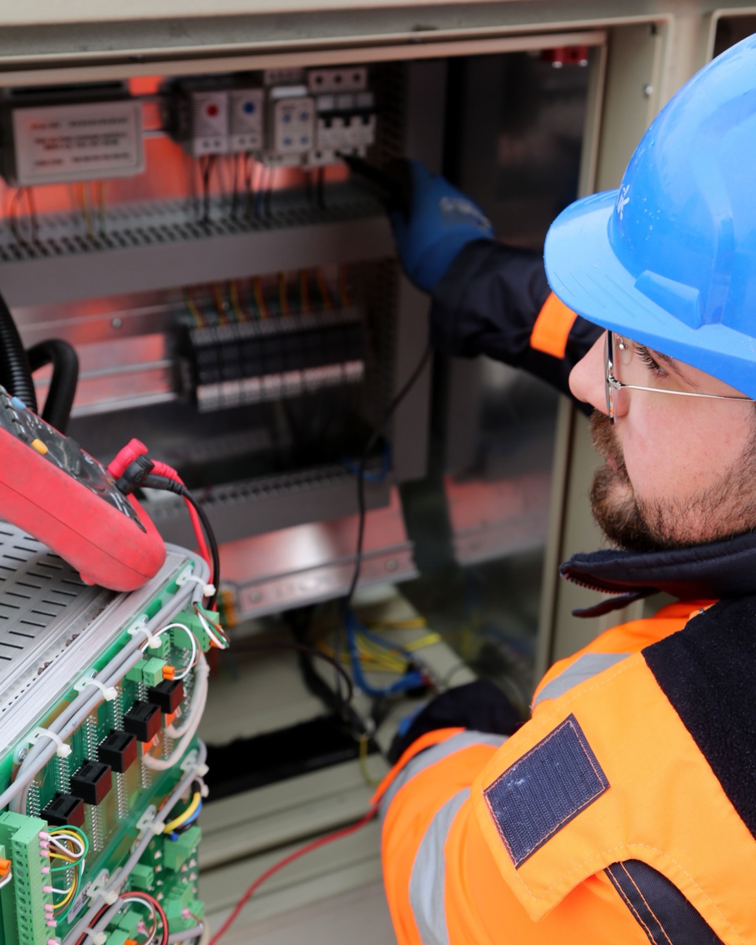 A WECA instructor at work on a control cabinet